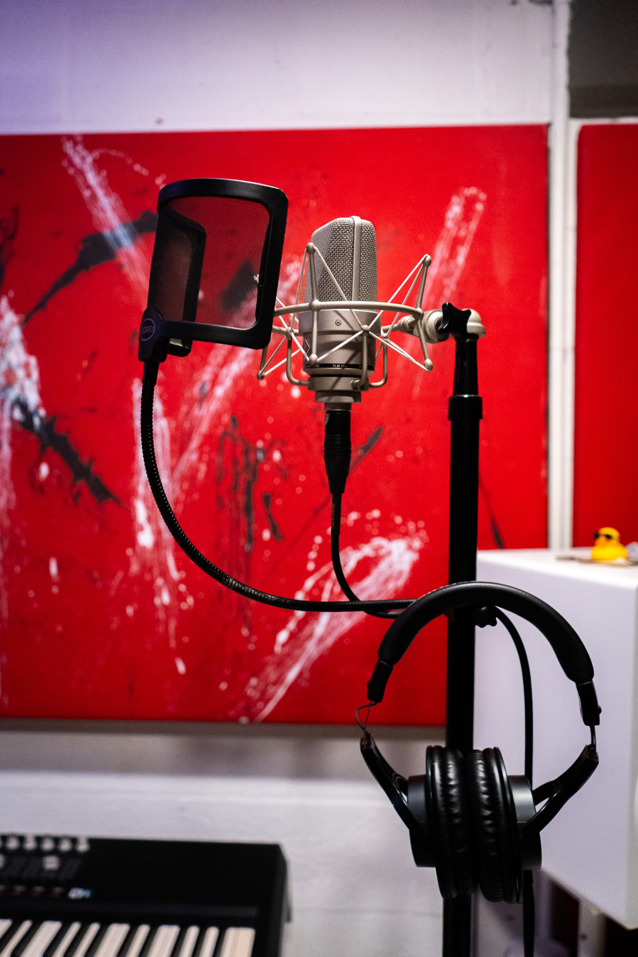 Condenser microphone and headphones in Studio B music room at ALL N 1 STUDIO